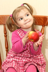 Fototapeta na wymiar The amusing babe with an apple