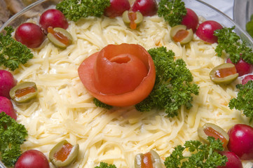 Decoration on fresh salad with cheese in glass bowl