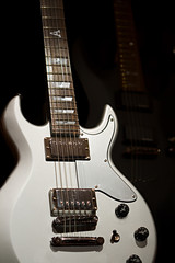Fototapeta na wymiar Silver and black guitars on a black background