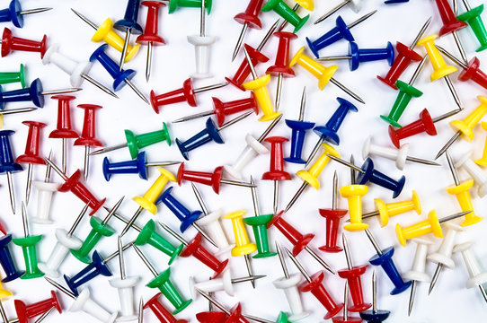 Colorful pins over the white background
