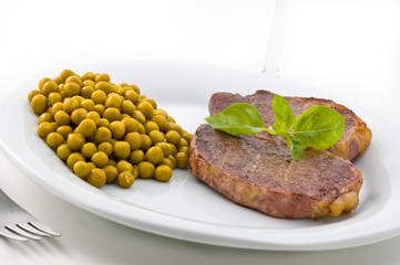 Dish of meat and peas with basil.