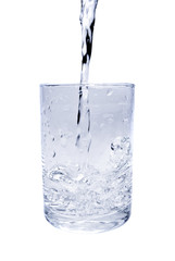 Water poured intro a glass isolated on a white background