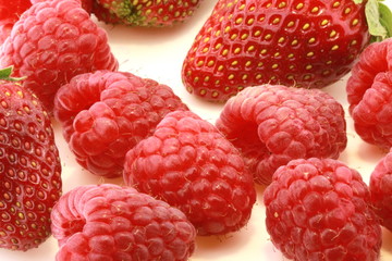 fresh strawberries and raspberries with white background