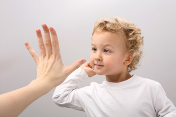 Child and adult clap hands.
