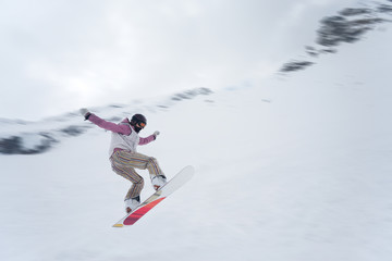 Naklejka na ściany i meble Girl with snowboard jumping of a hill