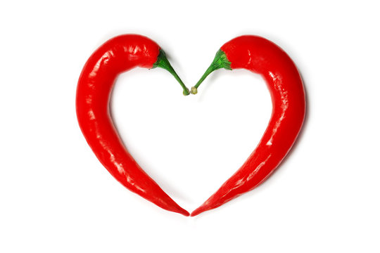 Two chili peppers forming a shape of heart. Hot lover symbol.