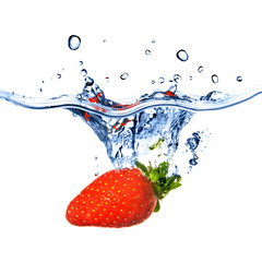 strawberry dropped into blue water with splash isolated on white