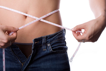 Woman measuring her waist, isolated on white background