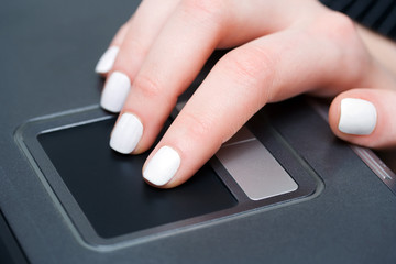 Female hand using touchpad.