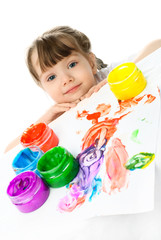 Fototapeta na wymiar little girl painting with finger paints
