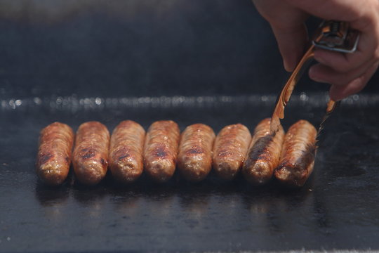 Sausanges On The Barbeque - With Tongs