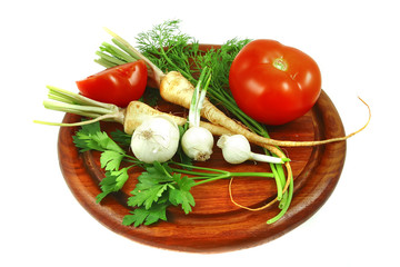 vegetables with tomato on wooden plate