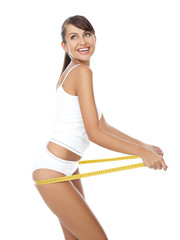 Young beautiful woman with measure tape on white