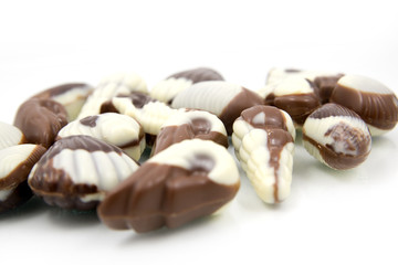chocolate sweetmeats in form seashell on white background
