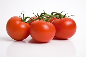 Bunch of tomatoes isolated on white background