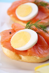 Smoked salmon on bagel with fresh black pepper.