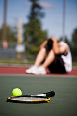 Sad tennis player after defeat