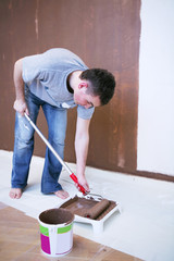 Painter using a paint roller