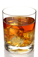 Glass of whiskey on rocks isolated on white
