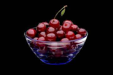 cherry in vase on black background