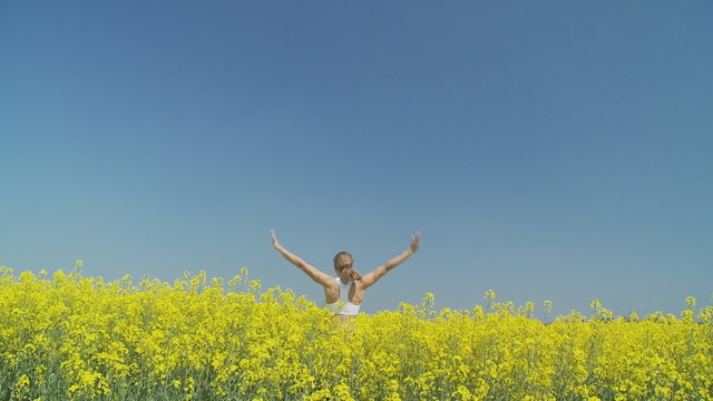 happy woman pivoting in rape field