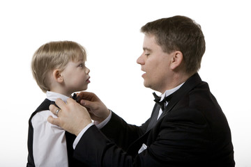 Man Fixing Bow Tie on a Boy's Suit