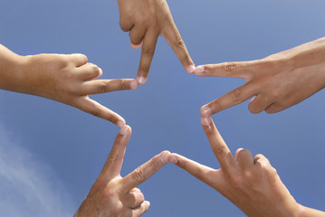 Hands together forming a star