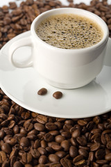 white cup of coffee and coffee beans