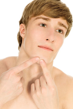 Man picking at acne