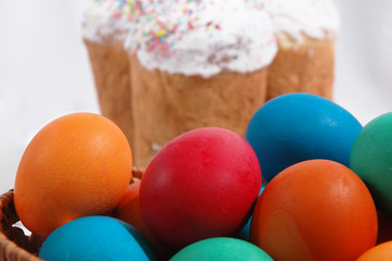 Fototapeta na wymiar Colored eggs on a white background with Kulich