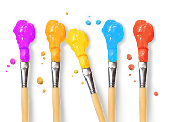 Bristle brushes full of different colored paints