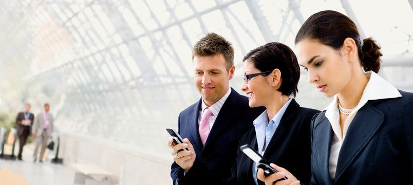 Businesspeople using mobile phone