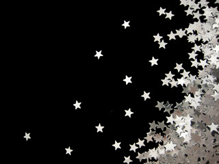 Silver stars confetti on black background