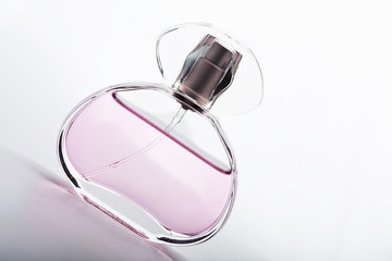 transparent bottle of pink perfume