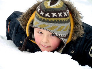 little boy on the white snow