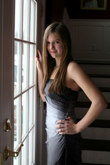 beautiful teenage girl in natural light by a French door