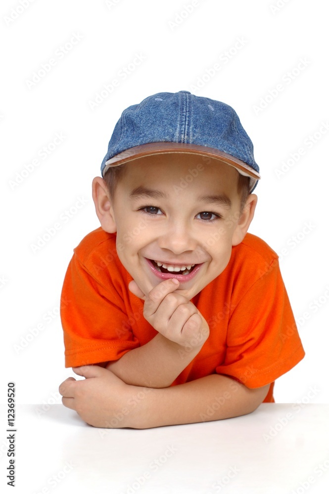 Wall mural smiling boy with denim cap, isolated on white