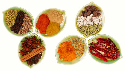 various Spices in six leaf shape plates isolated on  white