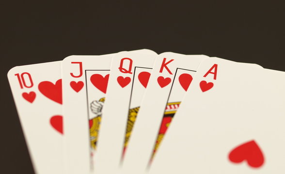 Poker in hearts on black isolated background.