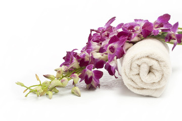 Spa objects on white background: pink blossoming orchid and towe