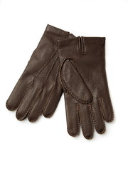Brown leather gloves over white background