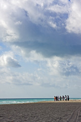 People holding hands at the beach