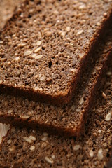 Slices of rye-bread on wood surface.