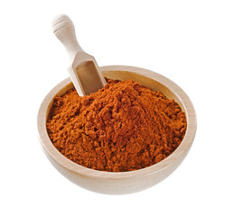 Ground paprika  in a wooden bowl