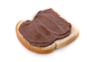 Hazelnut and chocolate spread over a slice of bread