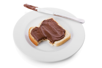 Bitten slice of bread covered with Hazelnut and chocolate spread