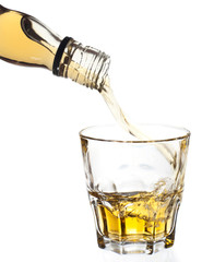 Fototapeta premium Whiskey pouring in glass, clipping path