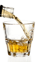 Whisky pouring in glass, isolated with clipping path