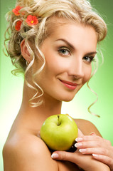 Beautiful young woman with ripe green apple