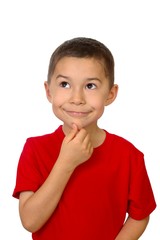 Seven-year-old boy looking up thinking, isolated on white